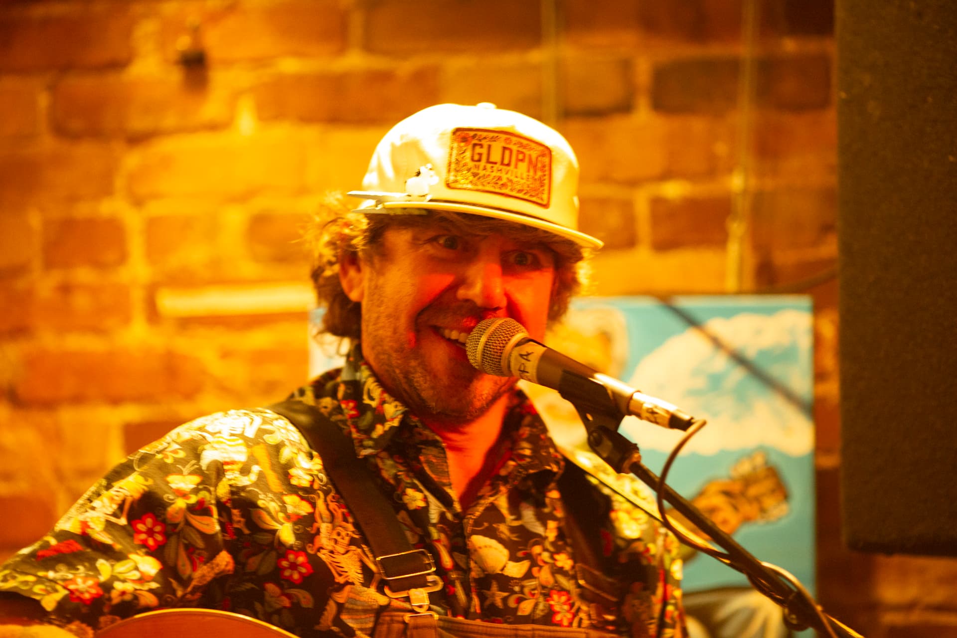 Ty Stonehawker smiling into the mic while performing