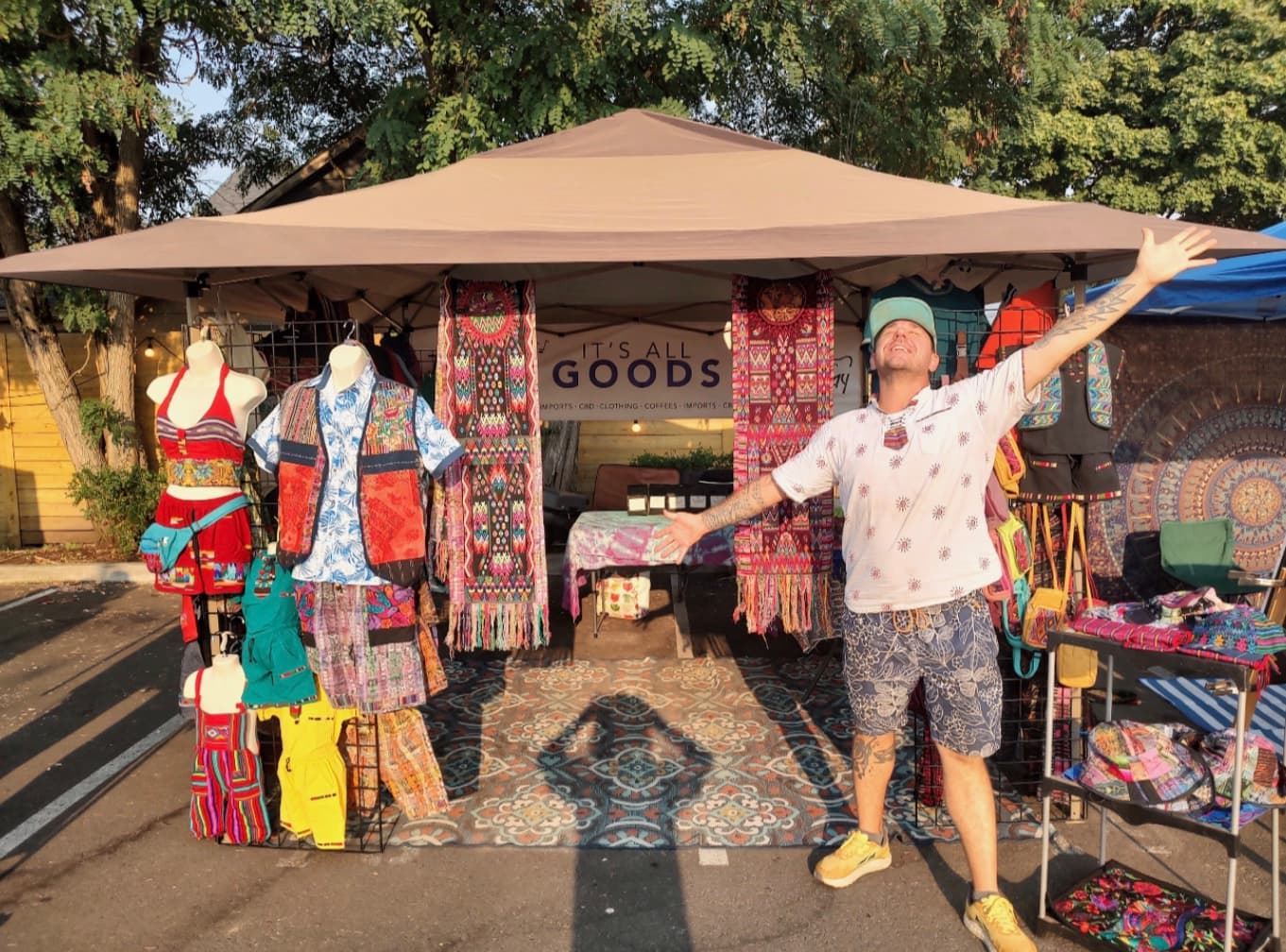 Ty presenting handwoven Guatemalan garments and textiles